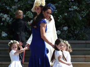 Canadian fashion stylist Jessica Mulroney hold bridesmaids hands as they arrive for the wedding ceremony of Britain's Prince Harry, Duke of Sussex and US actress Meghan Markle at St George's Chapel, Windsor Castle, in Windsor, on May 19. Jane Barlow/AFP