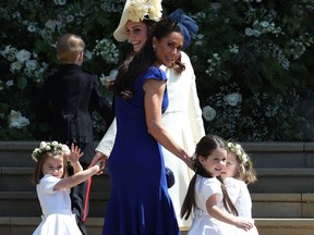 Canadian fashion stylist Jessica Mulroney hold bridesmaids hands as they arrive for the wedding ceremony of Britain's Prince Harry, Duke of Sussex and US actress Meghan Markle at St George's Chapel, Windsor Castle, in Windsor, on May 19. Jane Barlow/AFP