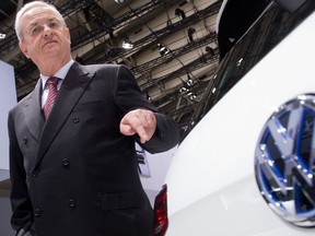 In this May 13, 2014 file picture then Volkswagen CEO Martin Winterkorn stands next to a VW car at the annual shareholder meeting in Hannover, Germany.