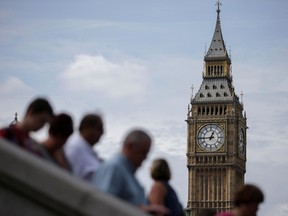 Tourists are pictured on Westminster Bridge beneath one of the four faces of the Great Clock of the Elizabeth Tower, commonly referred to as Big Ben, near the Houses of Parliament in central London on August 14, 2017. (Daniel Leal-Olivas/Getty Images)