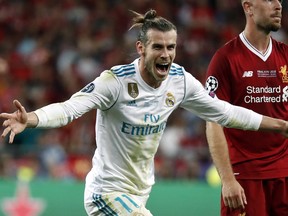 Real Madrid's Gareth Bale celebrates after scoring his side's third goal during the Champions League Final soccer match between Real Madrid and Liverpool at the Olimpiyskiy Stadium in Kiev, Ukraine, Saturday, May 26, 2018. (AP Photo/Pavel Golovkin)