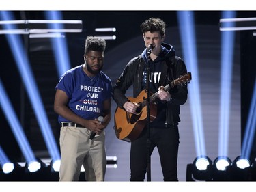 Khalid, left, and Shawn Mendes perform "Youth" with the Stoneman Douglas choir, of the Marjory Stoneman Douglas High School, at the Billboard Music Awards at the MGM Grand Garden Arena on Sunday, May 20, 2018, in Las Vegas.