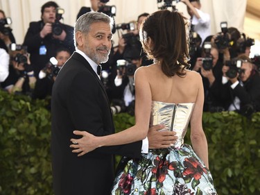 George Clooney, left, and Amal Clooney attend The Metropolitan Museum of Art's Costume Institute benefit gala celebrating the opening of the Heavenly Bodies: Fashion and the Catholic Imagination exhibition on Monday, May 7, 2018, in New York.