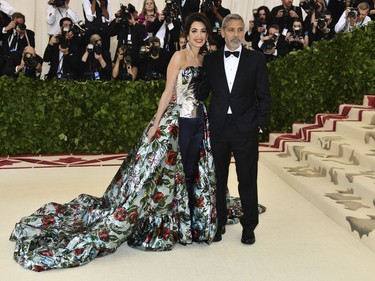 Amal Clooney, left, and George Clooney attend The Metropolitan Museum of Art's Costume Institute benefit gala celebrating the opening of the Heavenly Bodies: Fashion and the Catholic Imagination exhibition on Monday, May 7, 2018, in New York.