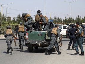 Afghan Security personnel arrive at the site of deadly attack on the interior ministry, in Kabul, Afghanistan, Wednesday, May 30, 2018. (AP Photo/Rahmat Gul)