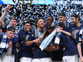 Jalen Brunson #1 of the Villanova Wildcats raises the trophy and celebrates with his teammates after defeating the Michigan Wolverines during the 2018 NCAA Men's Final Four National Championship game at the Alamodome on April 2, 2018 in San Antonio, Texas. (Tom Pennington/Getty Images)