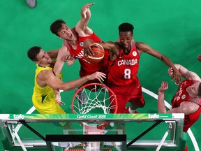 Erik Nissen (L) and Jean-Victor Mukama (R) of Canada rebound next to Daniel Kickert of Australia during the Men's Gold Medal Basketball Game between Australia and Canada on day 11 of the Gold Coast 2018 Commonwealth Games at Gold Coast Convention and Exhibition Centre on April 15, 2018. (Matt King/Getty Images)