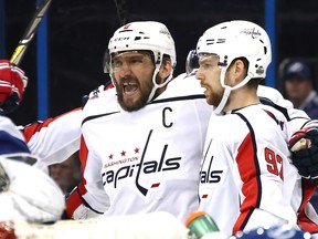 Alex Ovechkin of the Washington Capitals celebrates with teammate Evgeny Kuznetsov after scoring a goal in Game 2 of the Eastern Conference final at Amalie Arena in Tampa, Florida on May 13, 2018.