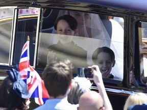 Meghan Markle is driven to St George's Chapel in Windsor Castle along with her page boys Brian and John Mulroney at St George's Chapel at Windsor Castle. (Toby Melville- WPA Pool/Getty Images)