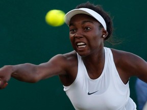 Canada's Francoise Abanda returns to Latvia's Jelena Ostapenko during their Women's Single Match on day three at the Wimbledon Tennis Championships in London on July 5, 2017