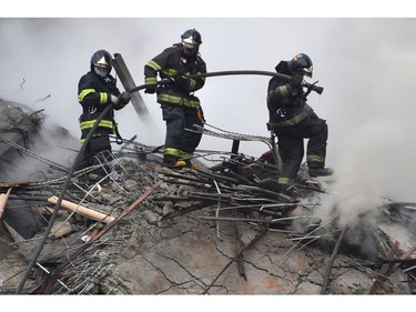 Firefighters work to extinguish the fire in a building that collapsed after catching fire in Sao Paulo, Brazil, on May 1, 2018.