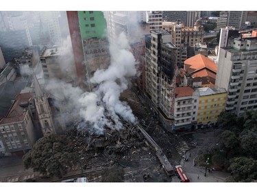 Firefighters work to extinguish the fire in a building that collapsed after catching fire in Sao Paulo, Brazil, on May 1, 2018.