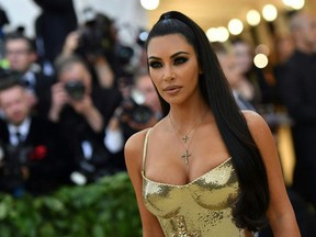 Kim Kardashian arrives for the 2018 Met Gala on May 7, 2018, at the Metropolitan Museum of Art in New York. The Gala raises money for the Metropolitan Museum of Arts Costume Institute. The Gala's 2018 theme is Heavenly Bodies: Fashion and the Catholic Imagination.
