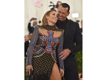 TOPSHOT - Jennifer Lopez and Alex Rodriguez arrive for the 2018 Met Gala on May 7, 2018, at the Metropolitan Museum of Art in New York. The Gala raises money for the Metropolitan Museum of Arts Costume Institute. The Gala's 2018 theme is Heavenly Bodies: Fashion and the Catholic Imagination.