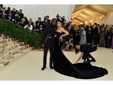 Kylie Jenner (R) and Travis Scott arrive for the 2018 Met Gala on May 7, 2018, at the Metropolitan Museum of Art in New York. The Gala raises money for the Metropolitan Museum of ArtÃ¢â¬â¢s Costume Institute. The Gala's 2018 theme is Ã¢â¬ÅHeavenly Bodies: Fashion and the Catholic Imagination.Ã¢â¬ï¿½