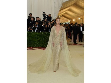 Rosie Huntington-Whiteley arrives for the 2018 Met Gala on May 7, 2018, at the Metropolitan Museum of Art in New York. The Gala raises money for the Metropolitan Museum of Arts Costume Institute. The Gala's 2018 theme is Heavenly Bodies: Fashion and the Catholic Imagination.
