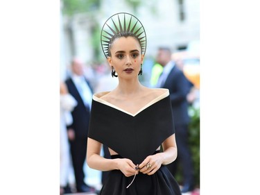 Lily Collins arrives for the 2018 Met Gala on May 7, 2018, at the Metropolitan Museum of Art in New York. The Gala raises money for the Metropolitan Museum of Arts Costume Institute. The Gala's 2018 theme is Heavenly Bodies: Fashion and the Catholic Imagination.