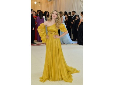Amanda Seyfried arrives for the 2018 Met Gala on May 7, 2018, at the Metropolitan Museum of Art in New York. The Gala raises money for the Metropolitan Museum of Arts Costume Institute. The Gala's 2018 theme is Heavenly Bodies: Fashion and the Catholic Imagination.