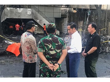 This handout photo released by the Presidential Palace on May 13, 2018 shows Indonesia's President Joko Widodo (2nd R) with officials at the scene of an attack outside the Central Pantekosta church (Gereja Pantekosta Pusat) in Surabaya.