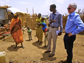 UN Under-Secretary General for Humanitarian Affairs and Emergency Relief Coordinator Mark Lowcock (R) talks with displaced Sudanese people as he visits a camp for Internally Displaced Persons (IDP) near Kadugli, the capital of Sudan's South Kordofan state during a United Nations humanitarian visit on May 13, 2018. (Ashraf Shazly/Getty Images)