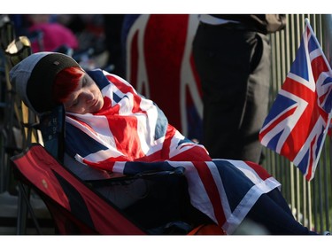 A Royal fan sleeps on the Long Walk leading to Windsor Castle ahead of the wedding and carriage procession of Britain's Prince Harry and Meghan Markle in Windsor, on May 19, 2018.