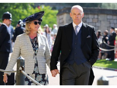 Former England rubby coach Clive Woodward and Jayne Williams arrive for the wedding ceremony of Britain's Prince Harry, Duke of Sussex and US actress Meghan Markle at St George's Chapel, Windsor Castle, in Windsor, on May 19, 2018.