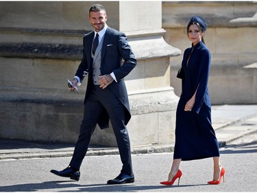 Former England footballer David Beckham (L) and fashion designer Victoria Beckham arrive for the wedding ceremony of Britain's Prince Harry, Duke of Sussex and US actress Meghan Markle at St George's Chapel, Windsor Castle, in Windsor, on May 19, 2018.