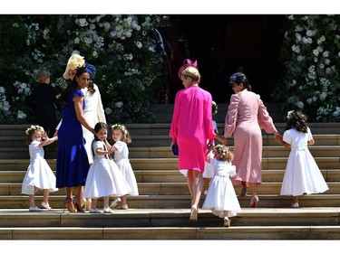 Britain's Catherine, Duchess of Cambridge (L) and Meghan Markle's friend, Canadian fashion stylist Jessica Mulroney (2L) holds bridesmaids hands as they arrive for the wedding ceremony of Britain's Prince Harry, Duke of Sussex and US actress Meghan Markle at St George's Chapel, Windsor Castle, in Windsor, on May 19, 2018.