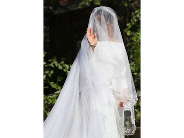 US actress Meghan Markle waves as she arrives for the wedding ceremony to marry Britain's Prince Harry, Duke of Sussex, at St George's Chapel, Windsor Castle, in Windsor, on May 19, 2018.