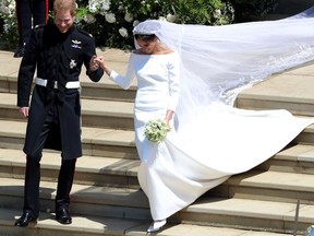 Britain's Prince Harry, Duke of Sussex and his wife Meghan, Duchess of Sussex emerge from the West Door of St George's Chapel, Windsor Castle, in Windsor, on May 19, 2018 after their wedding ceremony.