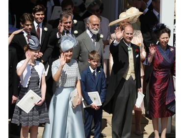 Members of the Royal family (L-R) Britain's Lady Louise Windsor, Britain's Sophie, Countess of Wessex, James, Viscount Severn, Britain's Queen Elizabeth II, Britain's Prince Philip, Duke of Edinburgh and Britain's Princess Anne, Princess Royal wave as Britain's Prince Harry, Duke of Sussex and his wife Meghan, Duchess of Sussex begin their carriage procession in the Ascot Landau Carriage after their wedding ceremony at St George's Chapel, Windsor Castle, in Windsor, on May 19, 2018.