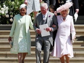 (L-R) Meghan Markle's mother Doria Ragland, Britain's Prince Charles, Prince of Wales (C) and Britain's Camilla, Duchess of Cornwall leave after  the wedding ceremony of Britain's Prince Harry, Duke of Sussex and US actress Meghan Markle at St George's Chapel, Windsor Castle, in Windsor, on May 19, 2018.