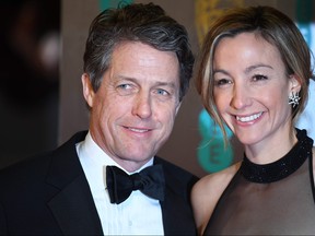 In this file photo taken on February 12, 2017, actor Hugh Grant and Swedish producer Anna Eberstein pose upon arrival at the BAFTA British Academy Film Awards at the Royal Albert Hall in London on February 12, 2017. (JUSTIN TALLIS/AFP/Getty Images)