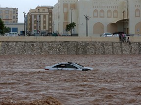 A picture taken on May 26, 2018, shows a car stuck in a flooded street in the southern city of Salalah as the country prepares for landfall of Cyclone Mekunu. Cyclone Mekunu was downgraded further to a deep depression Saturday, a day after lashing the southern coast of Oman and killing at least two people, authorities said. (MOHAMMED MAHJOUB/AFP/Getty Images)