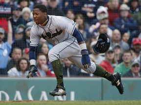 Atlanta Braves' Ronald Acuna Jr. begins to slide as he scores against the Boston Red Sox, Sunday, May 27, 2018, in Boston.