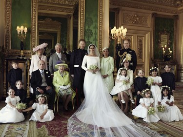 In this photo released by Kensington Palace on Monday May 21, 2018, shows an official wedding photo of Britain's Prince Harry and Meghan Markle, center, in Windsor Castle, Windsor, England, Saturday May 19, 2018. Others in photo from left, back row, Jasper Dyer, Camilla, Duchess of Cornwall, Prince Charles, Doria Ragland, Prince William; centre row, Brian Mulroney, Prince Philip, Queen Elizabeth II, Kate, Duchess of Cambridge, Princess Charlotte, Prince George, Rylan Litt, John Mulroney; front row, Ivy Mulroney, Florence van Cutsem, Zalie Warren, Remi Litt. (Alexi Lubomirski/Kensington Palace via AP) ORG XMIT: LON816