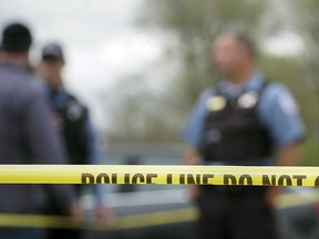 Police from various agencies investigate the scene where a Bureau of Alcohol, Tobacco, Firearms and Explosives agent was shot, Friday, May 4, 2018, in Chicago. (AP Photo/Teresa Crawford)