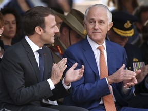 French President Emmanuel Macron, left, and Australian Prime Minister Malcolm Turnbull clap during a war commemorative ceremony in Sydney, Wednesday, May 2, 2018.