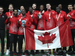 Members of the Canada men's basketball team stand with their silver medals at the Gold Coast Convention and Exhibition Centre during the 2018 Commonwealth Games on the Gold Coast, Australia, Sunday, April 15, 2018. (AP Photo/Mark Schiefelbein)