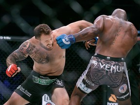 Ryan Bader, left, punches Muhammed Lawal during a heavyweight mixed martial arts fight at Bellator 199 in San Jose, Calif., Saturday, May 12, 2018.