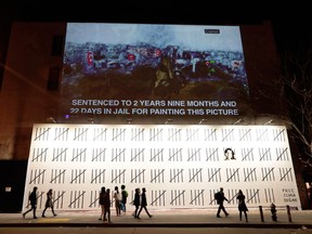 People pass by a mural by British graffiti artist Banksy protesting the imprisonment of Turkish artist Zehra Dogan in New York on March 16, 2018. An unauthorized exhibition featuring the work of mysterious British graffiti artist Banksy is headed to Toronto. Organizers say "The Art of Banksy" will make its North American premiere in the city on June 13 at 213 Sterling Road. Banksy's former agent, Steve Lazarides, curated the exhibit. THE CANADIAN PRESS/AP, Frank Franklin II