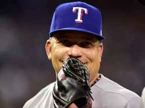 Texas Rangers starting pitcher Bartolo Colon reacts after catching a sharply hit comebacker to the mound from Toronto Blue Jays Kevin Pillar during MLB action in Toronto on April 28, 2018