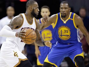 In this June 9, 2017 file photo, Cleveland Cavaliers forward LeBron James drives on Golden State Warriors forward Kevin Durant during the second half of Game 4 of basketball's NBA Finals in Cleveland