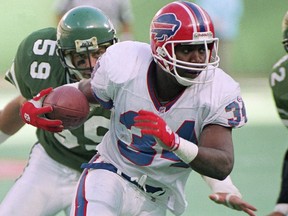 Buffalo Bills' Thurman Thomas carries the ball against the New York Jets at Giants Stadium in East Rutherford, N.J on Oct. 24, 1993. The Bills plan to retire Hall of Fame running back Thurman Thomas' No. 34 jersey on Oct. 29 when they host the New England Patriots. (AP Photo/Mark Lennihan)