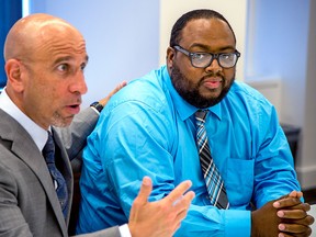 Khanefah Boozer, right, sits with his attorney Robert J. Levant on Thursday, May 10, 2018, after receiving the largest civil verdict against a city police officer.