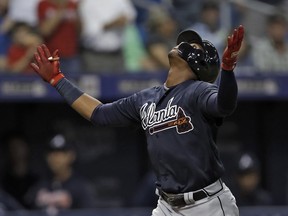 Atlanta Braves' Ronald Acuna Jr. reacts as he runs around the bases following his home run off Tampa Bay Rays starting pitcher Blake Snell during the third inning of a baseball game Tuesday, May 8, 2018, in St. Petersburg, Fla.