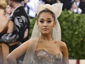 FILE - In this Monday, May 7, 2018 file photo, Ariana Grande attends The Metropolitan Museum of Art's Costume Institute benefit gala celebrating the opening of the Heavenly Bodies: Fashion and the Catholic Imagination exhibition. Grande has shared a message of hope with fans on the anniversary of the bombing at Manchester Arena that killed 22 people. The pop star on Tuesday, May 22, 2018 told survivors and the families of victims that she was thinking of them all " today and every day." The singer was performing at the arena when Salman Abedi detonated a suicide device last year.