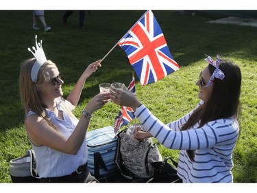 Women toast with Prosecco prior to the wedding ceremony of Prince Harry and Meghan Markle at St. George's Chapel in Windsor Castle in Windsor, near London, England, Saturday, May 19, 2018.