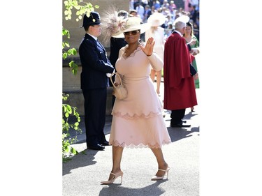 Oprah Winfrey waves as she arrives at St George's Chapel at Windsor Castle the wedding ceremony of Prince Harry and Meghan Markle at St. George's Chapel in Windsor Castle in Windsor, near London, England, Saturday, May 19, 2018. (Ian West/pool photo via AP) ORG XMIT: RWW107