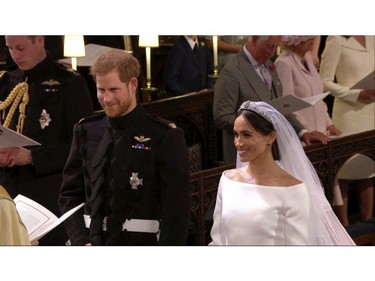 In this frame from video, Britain's Prince Harry and Meghan Markle stand during their wedding ceremony at St. George's Chapel in Windsor Castle in Windsor, near London, England, Saturday, May 19, 2018.  (UK Pool/Sky News via AP) ORG XMIT: NYAG106